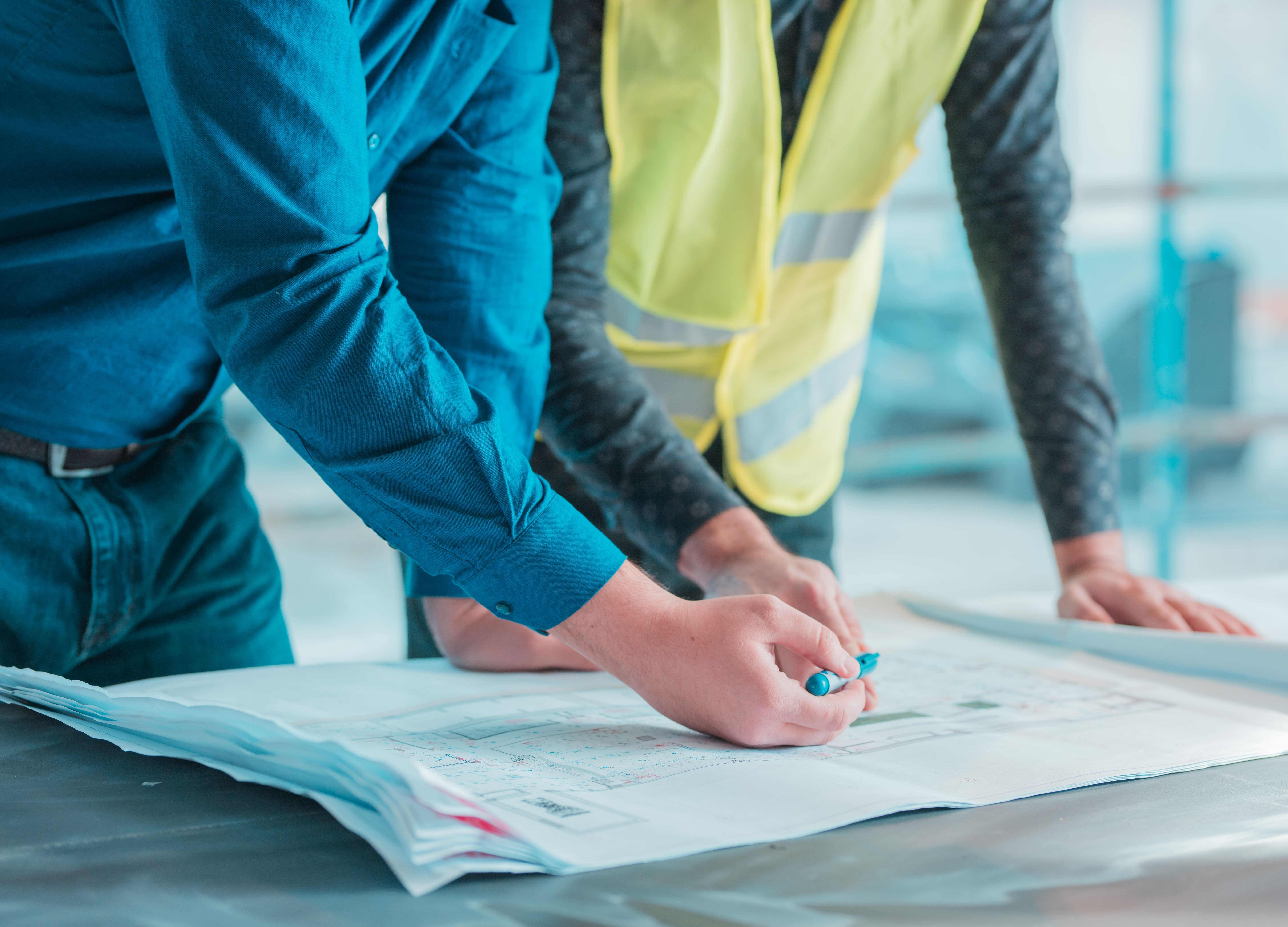 workers-checking-out-architectural-plan-project